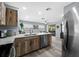 Open kitchen featuring stainless steel appliances, modern cabinets and eat-in counter space at 3355 Roslyn Rd, Venice, FL 34293