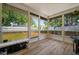 Relaxing screened lanai showcasing wood-look flooring and views of the fenced backyard at 3355 Roslyn Rd, Venice, FL 34293