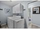 Functional laundry room with white appliances, cabinet storage, and convenient access to the adjacent bathroom at 3355 Roslyn Rd, Venice, FL 34293