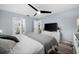Bright main bedroom featuring ceiling fan, gray flooring and en suite bathroom access at 3355 Roslyn Rd, Venice, FL 34293