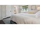 Comfortable bedroom with natural light, doorway to bathroom, and neutral color palette at 348 Dorchester Dr, Venice, FL 34293