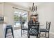 Dining area with backyard pool view, decorative chandelier, and stainless steel bar and shelf accents at 348 Dorchester Dr, Venice, FL 34293
