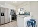 Modern kitchen with stainless steel appliances, breakfast bar with seating, and white cabinets at 348 Dorchester Dr, Venice, FL 34293