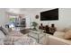Comfortable living room featuring hardwood floors, neutral walls, modern furniture, and pool view at 348 Dorchester Dr, Venice, FL 34293
