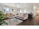 Inviting living room with neutral-toned couches, glass coffee table, dark wood floors and bright natural light at 348 Dorchester Dr, Venice, FL 34293