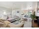 Open-concept living room with view of dining area, neutral decor, dark wood floors, and lots of natural light at 348 Dorchester Dr, Venice, FL 34293