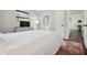 Comfortable main bedroom with wood flooring, TV, and neutral decor at 348 Dorchester Dr, Venice, FL 34293