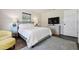 Cozy main bedroom featuring a seating area, window and TV at 348 Dorchester Dr, Venice, FL 34293
