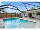 Screened pool with lounge chairs, dining set, and covered patio area at 348 Dorchester Dr, Venice, FL 34293