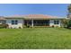 Green backyard, manicured with a patio and beautiful landscaping, offering ample outdoor living space at 353 Marsh Creek Rd, Venice, FL 34292
