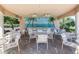 Outdoor community bar area with beach mural backdrop, ceiling fans, and seating at 353 Marsh Creek Rd, Venice, FL 34292