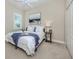 Cozy bedroom showcasing a comfortable queen-size bed with blue accents and a side table at 353 Marsh Creek Rd, Venice, FL 34292