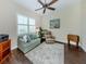 Cozy bedroom with ample seating, ceiling fan, neutral paint, and wood-look flooring at 353 Marsh Creek Rd, Venice, FL 34292