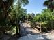 Wooden bridge crossing over a stream surrounded by trees at 353 Marsh Creek Rd, Venice, FL 34292