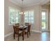 Bright dining area with modern chandelier and views of the outdoor living space at 353 Marsh Creek Rd, Venice, FL 34292