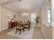 Formal dining area featuring a chandelier and neutral decor at 353 Marsh Creek Rd, Venice, FL 34292