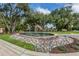 Beautiful water fountain surrounded by colorful rocks at the community entrance near lush landscaping at 353 Marsh Creek Rd, Venice, FL 34292