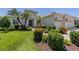 Beautiful landscaping with mature palms enhances this home's curb appeal at 353 Marsh Creek Rd, Venice, FL 34292
