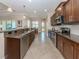 Modern kitchen featuring granite counters, wood cabinets, stainless steel appliances and adjacent dining area at 353 Marsh Creek Rd, Venice, FL 34292