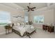 Spacious main bedroom features a tray ceiling, ceiling fan, and plantation shutters at 353 Marsh Creek Rd, Venice, FL 34292