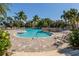 Gorgeous community pool with waterfall feature, surrounded by lush tropical landscaping and resort style amenities at 353 Marsh Creek Rd, Venice, FL 34292