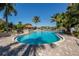 Community pool surrounded by tropical landscaping and resort-style amenities at 353 Marsh Creek Rd, Venice, FL 34292