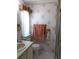 Cozy bathroom with floral wallpaper, sink, toilet, and shower behind patterned glass at 358 Longwood Dr, Venice, FL 34285