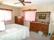 Traditional bedroom features wood furniture, ceiling fan, and natural light from the window at 358 Longwood Dr, Venice, FL 34285