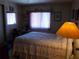 Bedroom features light fixtures and window with matching decor and floral bedspread at 358 Longwood Dr, Venice, FL 34285