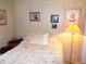 Neutral bedroom with plush carpet, floral bedspread, and assorted Gathering pictures at 358 Longwood Dr, Venice, FL 34285