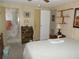Bedroom with en suite bathroom features wood paneling and neutral carpet at 358 Longwood Dr, Venice, FL 34285