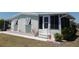 Inviting home featuring a cozy porch and a neatly landscaped yard at 358 Longwood Dr, Venice, FL 34285