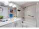 Bathroom features a tub with shower, grab bar, modern vanity, and coordinated tile at 360 Base E Ave # 413, Venice, FL 34285