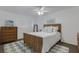 Cozy bedroom featuring a woven headboard, ceiling fan, and natural light at 360 Base E Ave # 413, Venice, FL 34285
