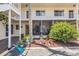 Exterior view of condo unit with screened patio and lush landscaping at 360 Base E Ave # 413, Venice, FL 34285