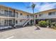 Low-rise condo complex featuring bright exterior, stairway to upper units, and a lush, well-maintained landscape at 360 Base E Ave # 413, Venice, FL 34285