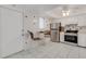 Modern kitchen featuring stainless steel appliances, white cabinets, and a breakfast area at 360 Base E Ave # 413, Venice, FL 34285