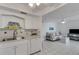 Bright living space connecting the kitchen and living room, featuring tile floors and comfortable furnishings at 360 Base E Ave # 413, Venice, FL 34285