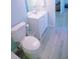 Cozy bathroom featuring a white vanity, toilet, and light wood-look flooring at 400 Base # 225, Venice, FL 34293