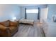 Inviting bedroom with chair, twin bed, dresser and neutral tones, creating a comfortable space at 400 Base # 225, Venice, FL 34293