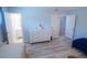 Light and airy bedroom with white dresser and gray vinyl floors with attached bathroom at 400 Base # 225, Venice, FL 34293