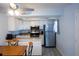 Bright kitchen with white cabinets, stainless steel appliances, and tile backsplash at 400 Base # 225, Venice, FL 34293