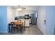 Bright kitchen with white cabinets, stainless steel appliances, and gray laminate flooring at 400 Base # 225, Venice, FL 34293