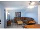 Cozy living room with a large sectional sofa, ceiling fan and neutral color palette at 400 Base # 225, Venice, FL 34293