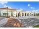 Beautiful building featuring multiple arches, well-maintained grounds and landscaping, and light-colored stucco at 400 Base # 225, Venice, FL 34293