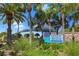 Welcoming Venice Beach sign surrounded by lush greenery and palm trees at 400 Base # 225, Venice, FL 34293
