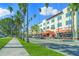 Charming street view of buildings, palm trees lining the road on a sunny day at 400 Base # 225, Venice, FL 34293