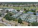 Beautiful aerial view of tennis courts near clubhouse, landscaping, and golf course in a serene community at 406 Cerromar N Cir # 128, Venice, FL 34293
