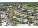 Aerial view showcasing a refreshing community pool surrounded by well-maintained grounds and mature palm trees at 406 Cerromar N Cir # 128, Venice, FL 34293