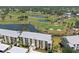 Aerial view of condo building with lush golf course and water views at 406 Cerromar N Cir # 128, Venice, FL 34293